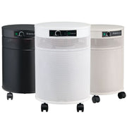 Three cylindrical air purifiers with wheels in black, white, and beige