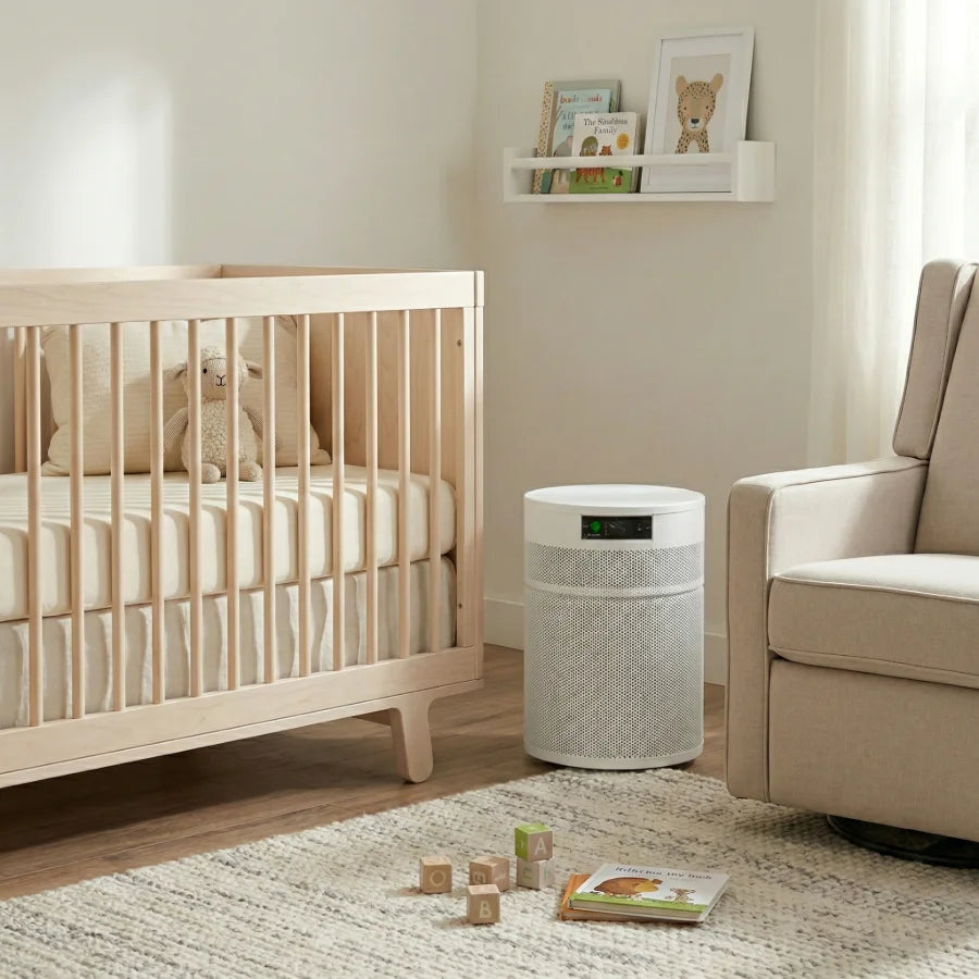 Nursery room with crib, white Airpura R400 air purifier, and armchair