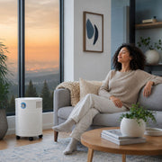 woman in living room with clean air with the Allerair airmedic pro 5 ultra s air purifier